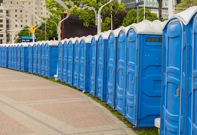 a row of portable restrooms set up for a large athletic event, allowing participants and spectators to easily take care of their needs in Avon Lake